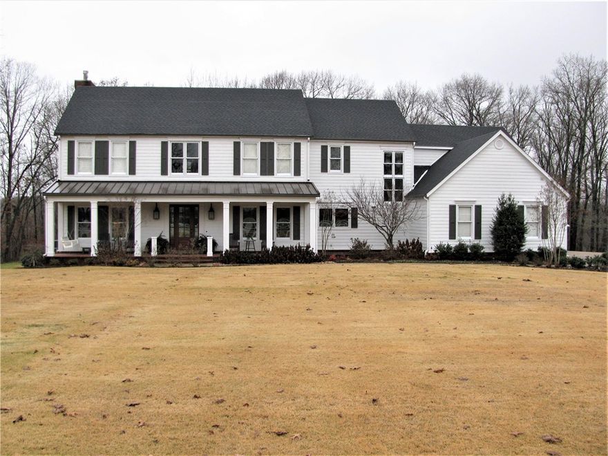 Beautiful estate home on 4.17 acres. Scenic paved drive through meadows surrounded by woods, cross bridge over Artesian spring, up small incline to the estate on large flat yard surrounded by natural wooded setting. Private location just few minutes to Hwy 72 & I-49. Only 3.5 miles Downtown Bentonville. Home updated throughout, upscale/magnificent, lots woodwork, extravagance/detail, yet comfortable with warm/inviting features; tall ceilings, wood floors/beams, 2 fireplaces, 2 staircases, lots built-ins, gourmet kitchen with magnificent island, stainless appliances: built-in refrigerator, gas range with griddle, microwave/convection oven combo, soap stone countertops. Home has 5 bedrooms, 4.5 baths, 2 living areas & study on main level; upstairs bonus room. 5th bedroom lower level has sink & microwave. Formal dining plus large breakfast area. 4 garage, large porch, huge deck, stone patio. Roof 2019. Hardie pre-painted exterior siding 2016. Two of the three HVACs replaced 2019. Septic tank recently inspected/pumped.