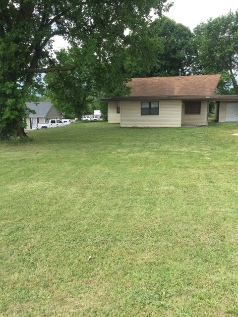 Location, Location, Location! North Thompson or 71 Business, huge traffic count daily! Zoned I-1 but can have conditional use or change if necessary, depending on business. Amazing .54 acres with house on it. Located in between Backstrom Funeral Home and a car lot, across street from Lewis Ford. House has 1 car garage, kitchen, 3 bedrooms, 1 bath, living room, and dining room. Hot water heater is gas, but has been disconnected, and gas range has been capped off, just due to owners used as storage and did not need that in use. Central heat and air, house can be used but value is in the land. Level lot. Gas easement at back of property. No repairs.