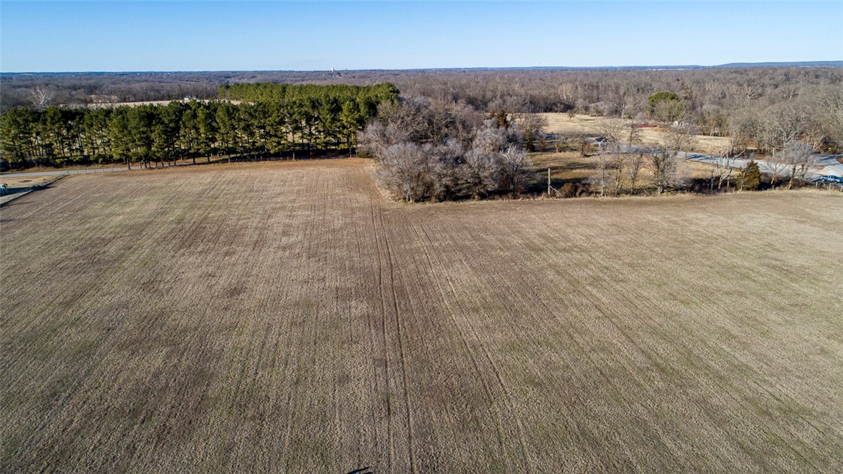 Executive Homes would be Perfect for 51.33 acres zoned for 3+ acre lots! Wooded & Open,Close to Rogers on Paved Road?Easy access!Gorgeous land,Get your family & friends and build some Dream Homes here!Development Potential. Electric, water and gas lines adjoin acreage. Get your family and friends buy it together and use it for yourselves! Strong development potential! acreage fronting Hwy 94 between Rogers & Pea Ridge. Rock ledge with spring. Daffodils encompass the old home site and extend all the way out to Hwy 94. The seller has created trails through the gorgeous wooded area. Wonderful area for upscale homes with larger lots, also smaller home development potential. Great place to build that hobby farm. Situated across Hwy 94 from Brush Creek Hills north entrance, on top of hill! There is plenty of room for entry and exits off Hwy 94. The parcel #’s are being changed due to the survey however Benton County will not change the parcel # until deed transfer so the parcel # is not correct in this information.