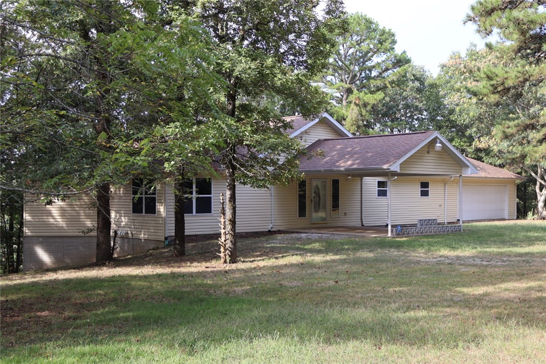 Come take a scenic drive near the Arkansas Grand Canyon just outside of Jasper to see this unique home! You’ll be greeted by a stunning entryway, cathedral ceilings, sunken living room, fireplace and plenty of large windows to take in the natural light. Enjoy slow mornings and peaceful evening sunsets on the covered back deck, you’ll be surrounded by quiet woods. The upper level of this home features 1979 Sq ft, generous master bedroom, walk-in closet and huge master bath showcasing a luxurious whirlpool tub! See also the dinning room and thoughtful kitchen, featuring vegetable sink and charming built-in bread box. The second bedroom boasts more of those incredible windows. Across the hall is a half bath, storage and W/D hookups. Downstairs you’ll find lots of extra space to be used any way you like- a den, two extra rooms, patio, bathroom, and if it wasn’t good enough- two massive hidden rooms with additional outdoor exits. It gets better with an oversized two car garage, built-in storage and a shed on 4.58 acres.