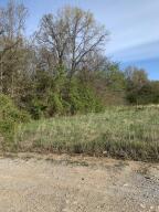 Prime lot with almost 2 acres. Great place to build a home with some of lot cleared. level land with trees to give you privacy depending on where you build. Water and electric are available. Outside the city limits. Double wide homes are allowed. Beautiful homes are already built here.