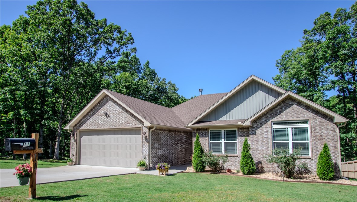 Modern 3 Bed, 2 Bath Home + Extra Lot Near Lake Ann! Built in 2022, this well-maintained home on Bella Vistaās NE side features polished concrete floors, an oversized 2-car garage, and custom upgrades throughout. Enjoy watching your favorite movie with surround sound while being cozy with the wood-burning fireplace in the living room. With the leather finished granite island and propane range, host friends and family in the spacious kitchen. The primary bathroom boasts ann original-antique curved claw tub, walk in shower and leather finished counter tops. Extra lot with gravel driveway includedāgreat for added privacy or future use. Minutes to Lake Ann and easy access to Hwy 71 & Pea Ridge!