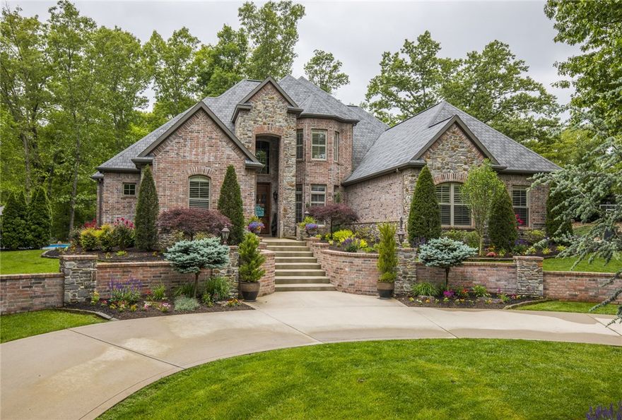 You truly can have it all! This stately home sits on almost 2.5 well manicured acres right on the Greenway.  Grand two story entrance grounded by beautifully refurbished barn wood floors welcomes guests into the foyer which leads to the formal dining room featuring coffered ceilings. Kitchen built for entertaining with ample bar seating, large center island & 48 in gas range flows into the living area with its modern rustic ceiling detail and stone fireplace. Tucked behind the living room you will find a media room & fitness area with easy access to a shower. Master suite features jetted bath, custom tile shower, plus his & her closets with built-ins! Smart floorplan includes additional main level bed which shares an en suite. Upstairs two more bedrooms have en suites, and there is a great game room with a bar! Bike to Crystal Bridges, Downtown, or Slaughter Pen in 10-15 minutes or enjoy your time at home enjoying the peace and serenity of the woods from one of your many patios, fireplaces, or soaking in the pool.