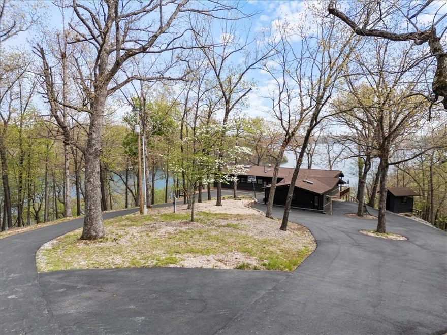 One-of-a-Kind Craftsman Style Home on ~10 Acres with 180° Lake Views, Private 4-Slip Dock w/swim deck & a New Shop Building. This stunning, custom-built home offers unmatched lakefront living with panoramic lake views from every room. Large windows flood the home with natural light and provide stunning views. Enjoy the tranquility and beauty of the water from the comfort of your covered porch----your front row seat to morning coffee sunrises or relaxing evening sunsets. Private Guest house with kitchenette, full bath and loft sleeping area. A new private asphalt road leads to your dock, making lake access a breeze. Inside, the home is filled with natural light, highlighting thoughtful details and views from every angle. The brand new 950 SqFt shop building is ideal for storage or hobbies. Whether you're looking for a full-time residence or a weekend retreat, this property delivers a rare combination of privacy, craftsmanship, and lakefront luxury.  New water purification and softener system. Wired for Hot Tub