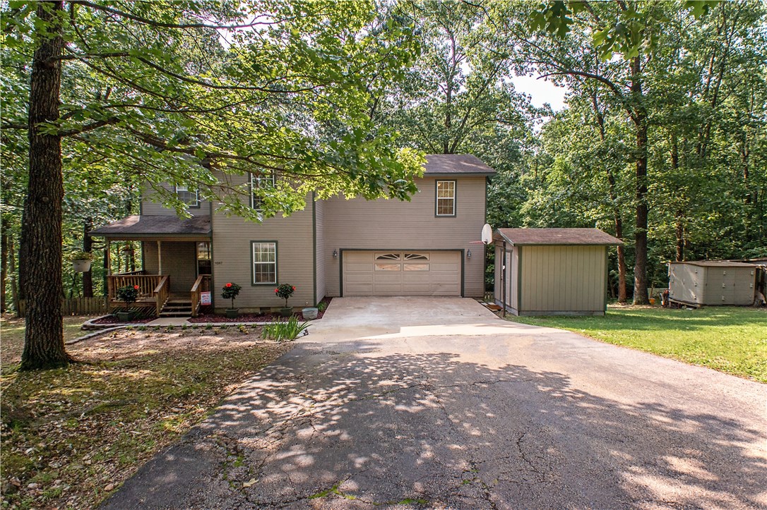 Nestled within the trees, this home sits on almost an acre of land. Home has an abundance of space with 2 living areas, additional storage, separate laundry room and spacious bedrooms. Recently updated with new carpet and fresh paint. Living room is cozy and offers wood burning stove, for those chilly nights. Lovely kitchen has granite counters and cabinets galore. Large deck overlooks fully fenced backyard, perfect area for the children! There is even a firepit area for entertaining! Great family home waiting for you!