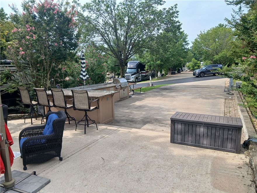 This beautifully landscaped lot is a pull-in and will accommodate up to a 45’ motorhome ( class A, and C) full hook ups with 30/50 amp power, parking space for golf cart and car(s). It offers a beautiful outdoor kitchen complete with large gas grill, gas 2-burner stove, refrigerator and sink, plus storage drawers and cabinet storage below, and is complemented with granite countertops. An additional large patio provides a great place for your outdoor furniture and spending your leisure time. There is also a centrally located guest pool, as well as an owner’s pool and clubhouse. A convenient on-site courtesy dock is available for guests who enjoy boating. Furnishings will not convey. 30 minute drive to Branson