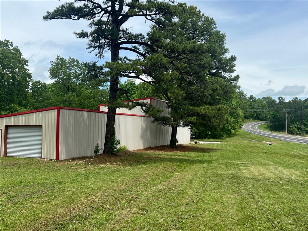 Looking for a place to start a business? The possibilities are endless on this 2.11 acre lot right on Hwy 74E only 7 minutes from the Jasper square and close to Hasty access to the Buffalo river. 20' x 100' Metal shop building with 3 roll-up garage doors (2-10'x8') (1- 10'x10'), 2 entry doors, with concrete floors and electricity including RV plugins around back, and in addition a small cabin with everything you need to be comfortable including full bathroom, mini kitchen, mini split for heat and air, and bedroom, with 2 porches. You bring the idea and this property can make it a reality!