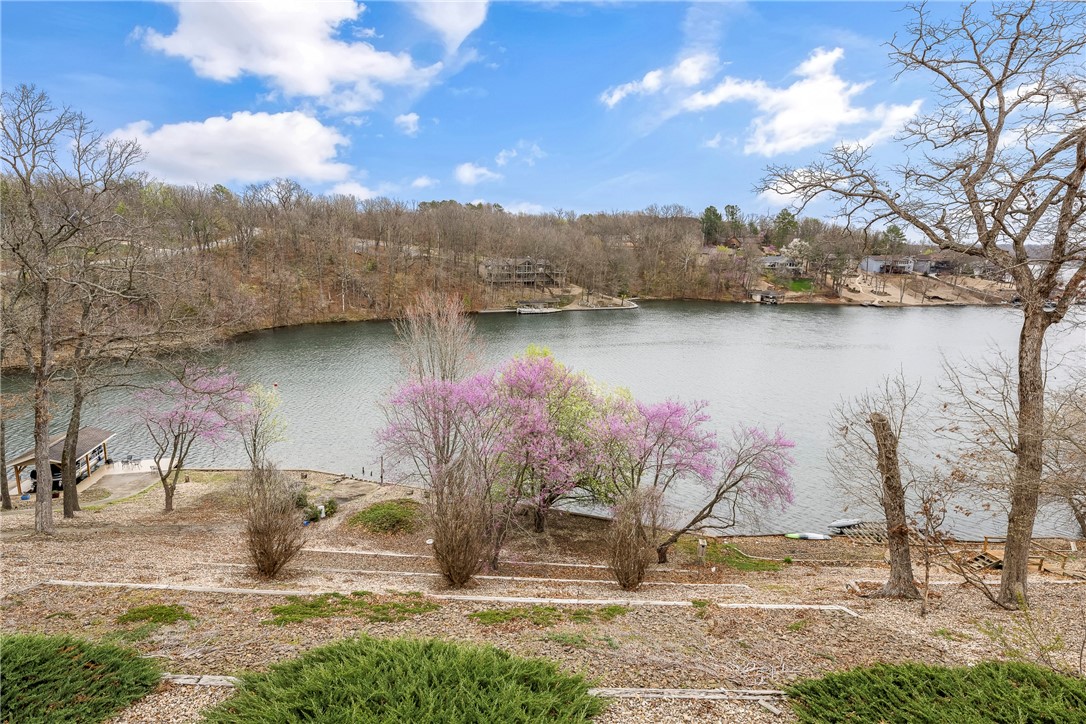 Waterfront with Stunning Loch Lomond Views! This two-level ranch-style home is ready for new owners to make it their own! Nestled on a quiet cul-de-sac, this property offers breathtaking water views & direct lake access. The main level features an open floor plan, two spacious bedrooms, & two full baths. The lower level, with its 9-foot ceilings, includes two additional rooms & a half bath—perfect for a guest suite, office, or entertainment space. Outdoor living is a dream here! Enjoy your morning coffee on the screened-in porch, fire up the grill on the elevated deck, or relax on the covered lower-level deck, which is just begging for some hammocks to soak in the lake breezes. Sitting on a low-maintenance .63-acre lot, this home also features a concrete path leading to a dock-ready area, with power already installed at the concrete seawall. Selling AS-IS & price reflects current condition. Oversized garage. Don’t miss this opportunity to own a peaceful lakeside getaway with unlimited potential.