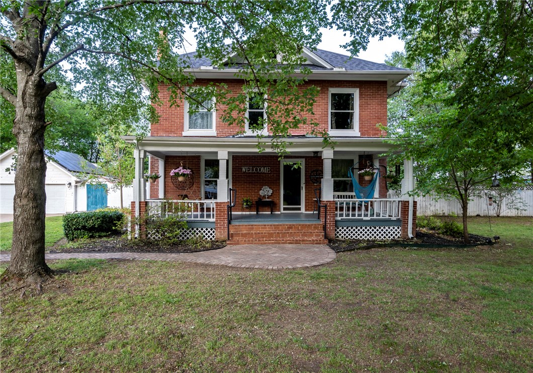 Classic Meets Contemporary...Step into timeless elegance with this beautifully preserved circa 1910 three-story historic home in the heart of downtown (see photos) Siloam Springs. Grand front porch, original wood floors, stunning built-ins, & classic charm blend seamlessly w/ a modern addition featuring a gourmet kitchen, open-concept living, expansive family room and primary bedroom suite. Sitting on a rare ¾-acre lot, the property offers potential for subdividing with access from a side street—ideal for an additional residence or guest house. Enjoy entertaining in the giant backyard oasis, complete with a covered porch, in-ground pool, and detached garage/workshop. Updates include a new roof (2022), solar panels (paid off), new pool pump, and humidity-controlled ion A/C unit under warranty. Leaf-shield gutters with a lifetime transferable warranty and a newer sump pump (approx. 2020) add peace of mind. Don’t miss your chance to own a unique piece of Siloam Springs history—modernized for today, with room to grow.