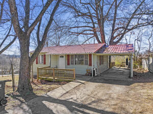 Well-kept 2BR/1BA home on corner lot in Harrison! This adorable home has Hardwood floors in the Living Room & both Bedrooms! It also has a metal roof, 1 car attached carport with concrete parking, and a portion of the side yard that is fully fenced for your pet! Not to mention that with an acceptable offer, all the appliances will convey, including the refrigerator, washer & dryer so this home would be perfect for the 1st time home-buyer or someone looking to downsize!