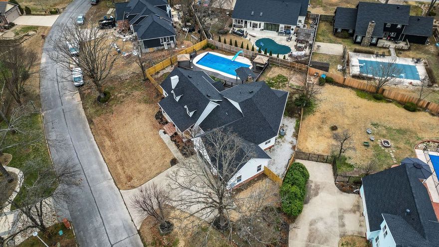 Experience luxury living near Downtown Bentonville in this meticulously designed 4,825 sq. ft. residence! With direct access to bike trails, strolling paths, and the dog park, this home blends convenience with an active lifestyle. Completely remodeled by a renowned local designer in 2019 and many updates since, it features an open-concept design perfect for entertaining. The gourmet kitchen boasts Quartz countertops, dual ovens, a gas cooktop, and premium finishes. Multiple living areas include a formal dining room, bar/game area, wet bar, and home theater. The primary suite offers a sitting area, a two-sided gas fireplace, a spa-like bath, and an oversized walk-in closet. Bedrooms 2 and 3 share a Jack-and-Jill bath, bedroom 4 is ensuite with a bonus room. Step outside to your private oasis with an in-ground gunite pool, slide, outdoor kitchen, covered fireplace, and TV lounge. Roof 2024. Ask for list of improvements. More than a home—it’s a lifestyle! Stroll or bike to dining, shopping, and Downtown Bentonville!