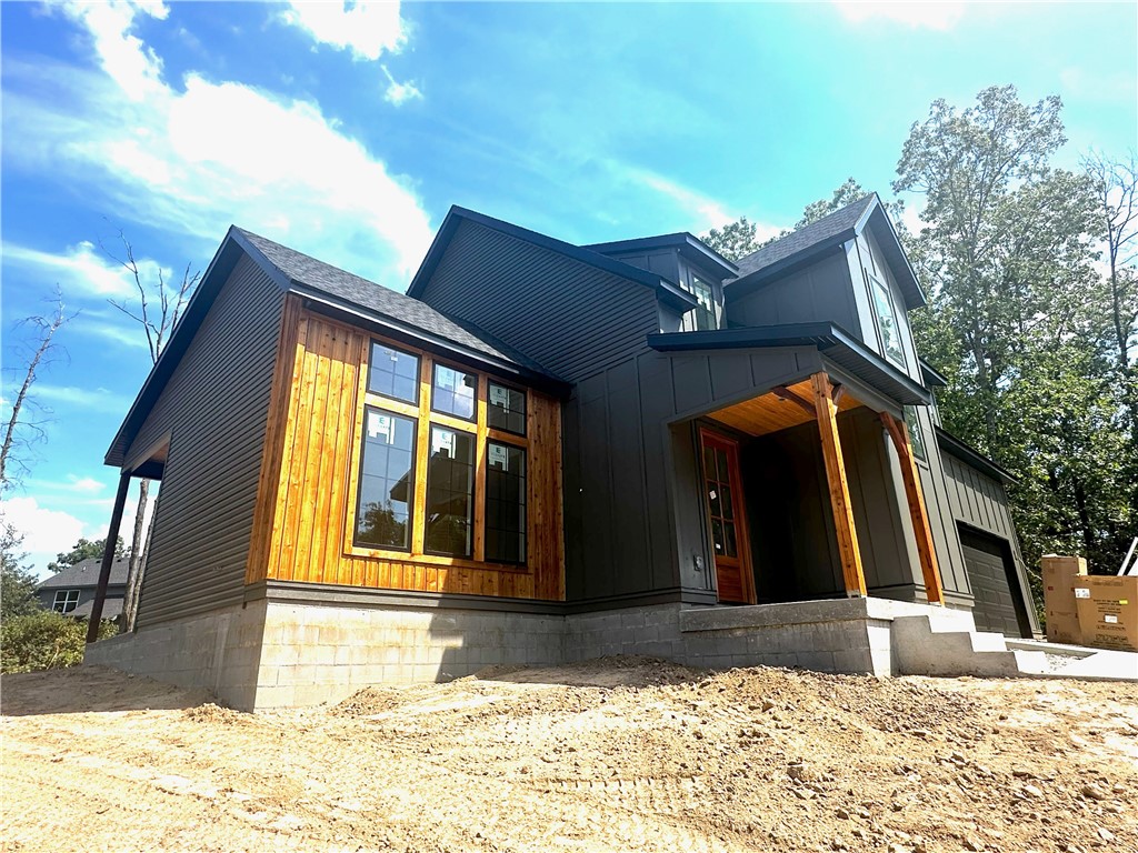 Gorgeous new showstopper on a large, flat lot your family will love to call home! Open your new front door to immediately be engulfed by streams of natural light beaming from the oversized windows along the back wall. A soaring ceiling with beams awaits you in the living room with an exquisite fireplace and more natural light from all the windows. Living room opens to the gorgeous kitchen with stainless appliances, modern cabinets, quartz countertops with a quartz waterfall island and large dining area. Primary bedroom on main level with big walk-in-closet including a washer and dryer hookup. The ensuite has dual vanities, custom tile shower and a soaker tub. Powder room and large garage with mud area round out main level. Upstairs, you’ll find a loft that would make a great flex space or office, two guest bedrooms, full bath, second laundry room and a bonus room (could be a 4th bedroom). A covered, corner back porch with wood ceiling opens to a huge flat backyard. Close to trails, Loch Lomand and lots of golf!