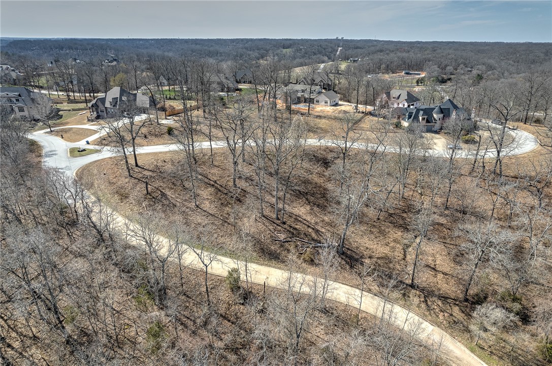 Rare chance to own a large lot in The Bluffs! Fabulous location to build your dream home and enjoy the views overlooking the woods, Coler Creek bike trail and the surrounding areas. Lot is just over one acre (+/-) with gentle slope. City utilities including water, gas, sewer. Land has been surveyed and adjoining lot also available for purchase in separate listing. Subdivision connects to Angel Falls subdivision.