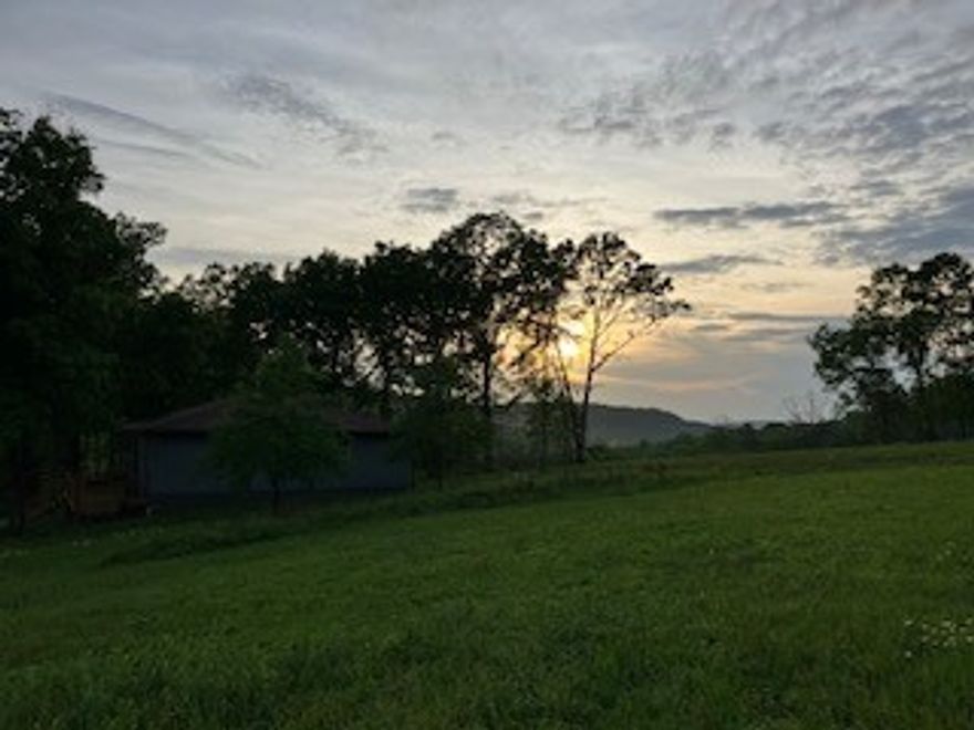 Experience country living at its best in this charming home located just outside of the historic town of Kingston AR. Home is constructed of stucco giving a unique and natural feel with Andersen windows, excellent insulation and sustainability. Renovation in 2023 includes new paint, cabinets, countertops and HVAC system.The open concept makes for a much larger feel. Two bed and 1 bath make up the living quarters, there is a full unfinished full basement that offers numerous possibilities. In addition to the 425 sq. ft covered porch, owners have added a 300 sq ft deck to enjoy the breathtaking sunrises and sunsets. Buried electric, fiber optic and well water are just a few features that enhance this properties comfort and convenience. The home sits on 40 acres that offers a near 360 view of the surrounding mountains. Property is partially fenced and mostly open with approx. 5 acres in woods. It offers a small catch pen for livestock, 3 ponds, one of which is stocked. Will sell with more or less acreage!