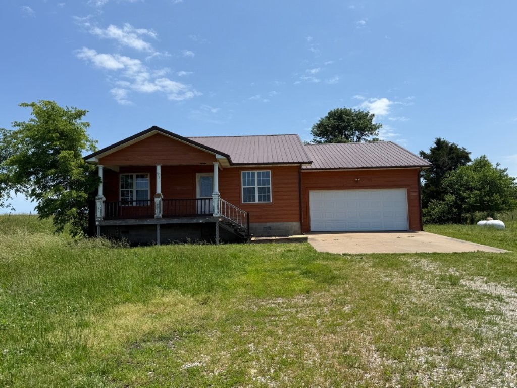 Frame home located north of town on approx. 0.77 acre with views of farmlands and rolling hills. This house features a metal roof, covered front porch, eat in kitchen, and water from shared well. Quick access back into town and just south of the MO Stateline with close access to Table Rock Lake and Kings River. Some renovation will be needed to make move in ready. Sold as-is, no repairs.
