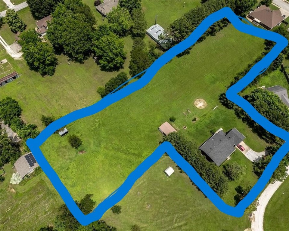For privacy and space in the middle of town, come see this 1,486 SF, 3 BR, 2 BA brick home sitting on 2.46 acres at the end of a cul-de-sac street. The home is in fantastic condition, has a 2-car garage, an open two acre level yard behind the house with 5 raised flower or vegetable garden planters, an 8x10 storage building, large covered front porch, covered back porch with a nice 4x8 inground storm shelter, a wood stove in the living room, and a marvelous kitchen and dining area. New roof in 2019 and new HVAC in 2022. PLUS - the refrigerator conveys to buyer! VERY NICE!