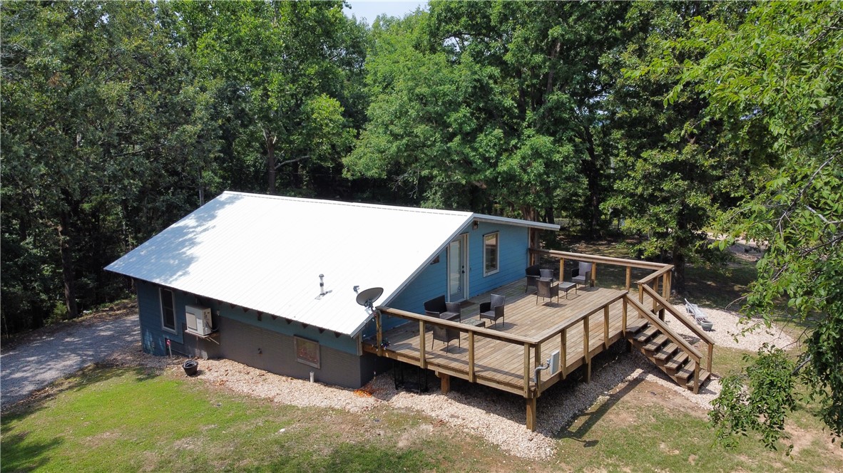 If you're looking for a private, peaceful getaway nestled in the woods of Eureka Springs this property checks all the boxes! Amazing lake area cabin with a stunning view of Beaver Lake. Sits on 1.87 acres with two amazing firepit locations. There is an expansive deck and a seperate paito to lounge or grill. A separate shed for storage of all your lake accessories. Large floor to ceiling windows for lots of natural light. Two large size living areas, Full size kitchen, Large open dining area, space for full size washer and dryer. A roomy full size bathroom. This property comes with access to the Glenn Acres Property Associations private lake area. Dont miss out this lovely unique and incredible property! All furnishings are negotiable.
