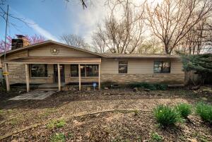 Looking for loads of space at a great price? This 3 bedroom 1 bath home boasts an open concept, 2 large living rooms, one with vaulted ceilings and a stone covered wood burning fireplace, original hardwood floors throughout, huge master bedroom that walks out to a deck in the back yard. Bring the enormous yard back to the outdoor oasis it once was with a little bit of elbow grease! Plenty of room in the master to create another bathroom! Heat is in working order but air conditioner may need some help to keep up with Arkansas summers. New window units will convey. With just a bit of work, this home could be a dream home!