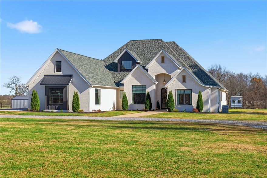 The absolute DREAM just hit the market!   This stunning custom home sitting on 5.33 acres of picturesque land. 4 bedrooms + office + media room, 3.5 baths, & a 3-car garage, all on one level!  The curated design features a large living room with a beautiful stone fireplace & mantle, complimented by wooden beams, 8' tall doorways throughout. Sliding patio doors from both the living room & media room, leading to a spacious covered patio with its own fireplace. The kitchen boasts top-of-the-line JennAir appliances, a built-in fridge with cabinet front panels, & two beverage fridges (in the kitchen & media room). The pantry AND laundry room includes a convenient sink. Additional highlights include speakers throughout on separate zones, insulated garage doors, remote blackout shades in the primary suite, a fenced backyard with room for a few cows and chickens, an electric fence for pets, a 3-sided pole barn. Lean-to and chicken coop may be purchased separately.