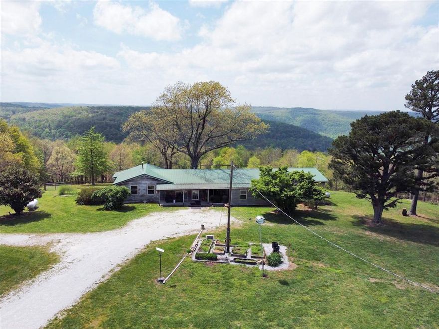 This is the best of Ozark living with this versatile 4-bedroom, 2-bath home on approximately 27 acres in beautiful Jasper, Arkansas, offering breathtaking mountain views stretching across the entire back of the property. Perfectly suited for multi-generational living, the home features a private 2 bedroom, 1 bath mother-in-law suite complete with its own kitchen and separate living space. Inside, you’ll find a spacious open great room along with a large pantry area that provides ample storage for everyday living. Step outside and enjoy a fully fenced and cross-fenced property ideal for livestock or horses.

Equestrian enthusiasts will appreciate the impressive setup, including a 6-stall horse barn and riding arena, while the large pond adds both beauty and functionality to the land. A 5-car detached garage offers plenty of room for vehicles, equipment, or hobbies.

All of this is set against the stunning backdrop of the Ozark Mountains, just minutes from the charm of Jasper and the Buffalo National River.