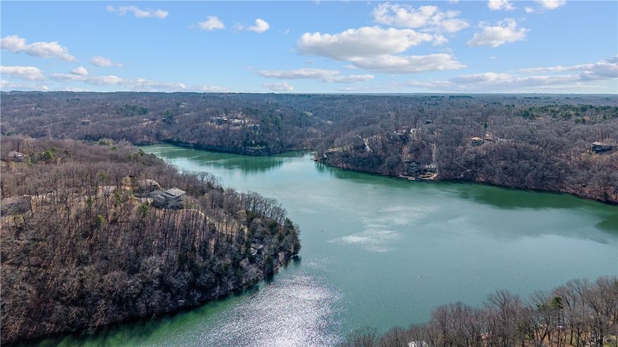 If you have ever wanted a true lakeside retreat, here it is on Lake Ann in Bella Vista, AR! This 4bed/3.5 bath home had a full main level remodel in 2021, over $300k+ spent, (See attachment). Vaulted ceilings, open concept, eat in custom kitchen with oversized island, 2 story, real stone, wood fireplace with blower.  Primary bedroom on main level.  Sunroom currently being used as owner/artist’s personal art studio. Lake views from every room! Loft area with 2 bedrooms, walk-out basement with second kitchen, second master, bonus room, and a potential 5th bedroom.  Lower level primary opens out to a serene, lakeside living space with firepit and lake view.  Outdoor dry rock sauna and shower for after a long day on the lake!  The 2-tier dock with new storage building provides ample space for sunny days, pontoon boat and trailer may convey with acceptable offer. 10 minutes to the new OZ Bike Lift and bike to The Back 40! All home systems have been regularly serviced, new roof in 2019/new HVAC in 2018