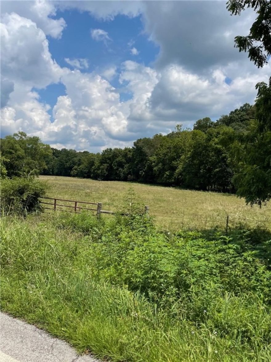 Beautiful acreage just north of Pea Ridge on Hayden Rd! Property is three parcels totaling 45.09 +/- acres of mostly flat pasture! Country feel with a short 20 minute drive to either downtown Rogers or Bentonville on all paved roads. Great spot for cattle or livestock with nice spring originating on property & Otter Creek running through property.  Currently has cows on property.  Majority of the property does lay in 100 year floodplain - bring some dirt in and build your dream home. Property taxes reflect what seller is currently paying with the 65+ tax freeze. Taxes are subject to change after sale.