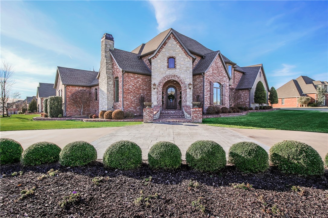 First time on the market! This elegant custom-built Country French-style home in Pinnacle Country Club is situated on a 0.51 acre corner lot with front circle drive. Entertain formally in the stylish living room with limestone fireplace and vaulted ceiling with wood beams or in the intimate dining room with wet bar. The heart of the home boasts a two story family room, upscale kitchen with custom cabinets, center island, and top of the line stainless appliances. The main level home theater is a must see with stadium seating, Lutron scene lighting, & beverage center with ice maker. A private executive office features numerous built-ins. Recharge in the main level master with luxurious bath, his and her vanities, and walk in closet. The additional main floor bedroom has a full bathroom that doubles as a pool bath. Upstairs offers additional living space in the bonus room loft with half bathroom, storage closet, and veranda access. Two additional bedrooms with a jack-and-jill bathroom finish off the upstairs.