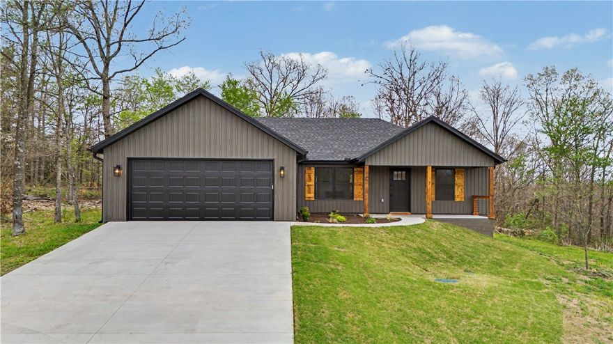 Two bedrooms PLUS office! Bring your boat and your pickleball paddles! Just half a mile to the Stoneykirk ramp for access to Loch Lomond lake and less than 1.5 miles to the Branchwood Rec Center for indoor pool, fitness and pickleball! Less than 4 miles to the Bella Vista Bypass for a non stop trip to Bentonville! Modern curb appeal with dark vinyl siding and cedar accents.  This home features finishes you'd expect in a higher price point house.  Designer kitchen with large island, pantry, stainless vent hood, great cabinet space, lighting and quartz counters. Split bedroom plan with a primary suite with a surprisingly large walk in closet, fully tiled shower and double vanity. Great covered porch off your dining space perfect for your morning coffee as you overlook your LEVEL back yard.  Gas log fireplace separates the living space from your kitchen/dining area.  Enjoy all that Bella Vista has to offer! *Photos of previous build of same plan. New photos coming soon!