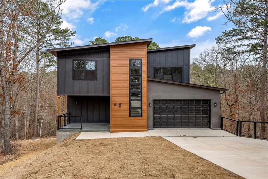 Refined Modern Luxury in a Private Cul-de-Sac Setting.Experience elevated living in this striking modern residence tucked away in a quiet cul-de-sac near the Back 40 bike trails, Lakes:Norwood & Ann. Thoughtfully designed with clean architectural lines,this home offers 3 beds, 2.5 baths,plus a private office.The open-concept layout delivers effortless flow between living,dining & kitchen spaces, enhanced by soaring ceilings & expansive windows filled with natural light. High-quality finishes & contemporary details create an elegant yet inviting atmosphere.A beautifully built rear deck ideal for entertaining pairs perfectly with a fabulous front porch adding charm & everyday comfort.The walkable backyard further sets this home apart. Surrounded by trails,lakes & the natural beauty of NWA,this home blends modern luxury,privacy & lifestyle-driven living.Photos are for illustrative purposes;finishes are similar to the completed residence.Taxes are estimated & subject to reassessment upon completion of new construction.