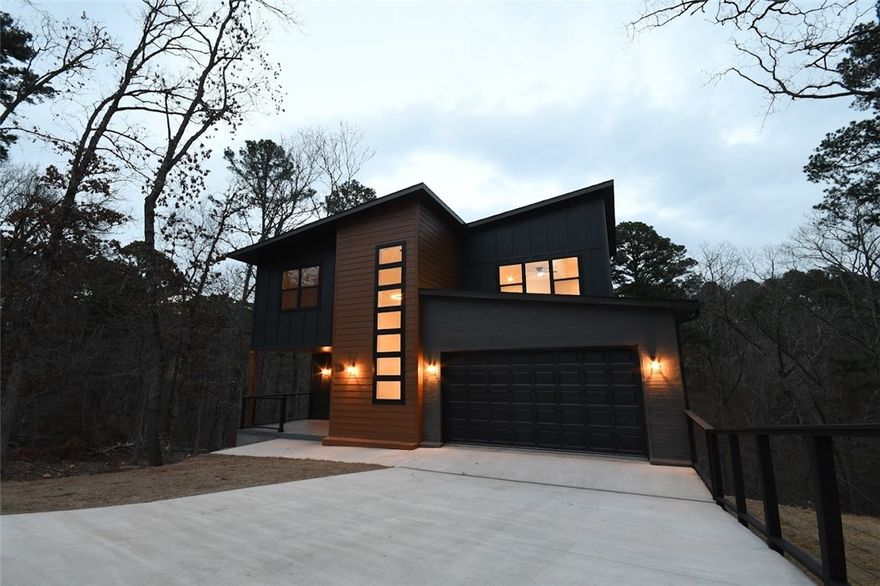 Refined Modern Luxury in a Private Cul-de-Sac Setting.Experience elevated living in this striking modern residence tucked away in a quiet cul-de-sac near the Back 40 bike trails, Lakes:Norwood & Ann. Thoughtfully designed with clean architectural lines,this home offers 3 beds, 2.5 baths,plus a private office.The open-concept layout delivers effortless flow between living,dining & kitchen spaces, enhanced by soaring ceilings & expansive windows filled with natural light. High-quality finishes & contemporary details create an elegant yet inviting atmosphere.A beautifully built rear deck ideal for entertaining pairs perfectly with a fabulous front porch adding charm & everyday comfort.The walkable backyard further sets this home apart. Surrounded by trails,lakes & the natural beauty of NWA,this home blends modern luxury,privacy & lifestyle-driven living.Photos are for illustrative purposes;finishes are similar to the completed residence.Taxes are estimated & subject to reassessment upon completion of new construction.