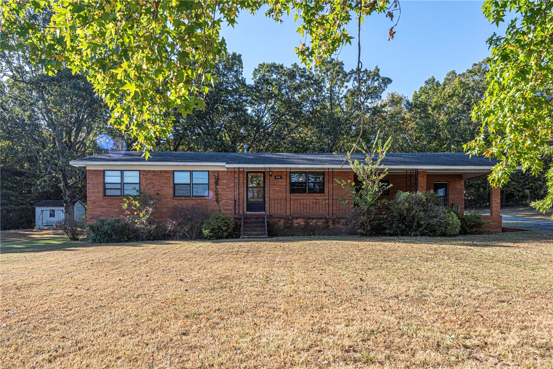 WELCOME HOME! This 3 bedroom 2 bathroom home on 2 acres (+/-) is located minutes away from I-49 Greenland Exit, Schools, drake field and less than 6 miles from University of Arkansas Campus and Downtown Fayetteville! From the covered front porch head inside to the main living room. Flow into the formal dining room and galley kitchen with lots of cabinetry and separate range & oven! Off the kitchen enjoy a second living room perfect for a media space! Head out back to the covered deck perfect for enjoying the upcoming fall season! Storage options included with 14x46 detached garage/carport and a 12x12 storage building. Property also has lot split potential! Donāt miss out on this home! Act now!
