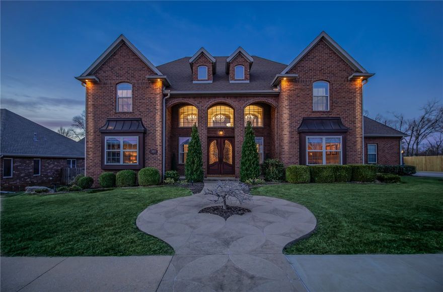 Nestled in a prime location minutes from Coler Mountain Bike Preserve, Downtown Bentonville, and the new Walmart HQ, this 4-bedroom, 4.5-bathroom home blends timeless elegance with character & sophistication. Thoughtfully designed with custom millwork, elegant archways, and high-end finishes, it offers a perfect balance of luxury and comfort. Step into a grand foyer with soaring ceilings, a dramatic staircase & expansive windows that flood the home with natural light. The main level features a formal dining room, office/second living space & spacious living room with vaulted wood ceiling, built-in shelving, & fireplace. The gourmet kitchen boasts custom cabinetry, a gas range with pot filler, island, & elegant granite countertops. The primary suite has a jetted bathtub, walk-in shower, dual vanities, and an oversized walk-in closet. Upstairs features a media/bonus room, 3 additional bedrooms, 3 bathrooms & dedicated fitness room. Enjoy outdoor living on the covered back porch, overlooking a large, flat backyard.