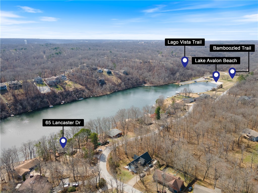 Lake Avalon is largest no-wake lake, perfect for fishing, swimming, kayaking, or paddle-boarding -132' of frontage on main part of lake - delightful treed lot with lots of deck areas to enjoy the breeze - great flexible floor plan in this stone and vinyl home - curved stone fireplace in living room - lots of windows - custom eat-in kitchen with pantry, drawers, pull-outs, soft close, slide outs etc - dining overlooking the lake - bedroom, den and bath on main level - lower level has large family room with fireplace and window seats, office area, large primary bedroom, bath has walk-in shower and dual vanities, large closet and laundry with sink - dual fuel heat pump - not your normal floor plan - stone walls - oversized garage - split driveway plus parking/turn around area - steps to lake where you can enjoy a picnic area, firepit and large dock - just up the hill from Lake Avalon Beach - lots of personal details add to the welcoming feel of this home - brand new roof - also new septic tank and septic tank pump -