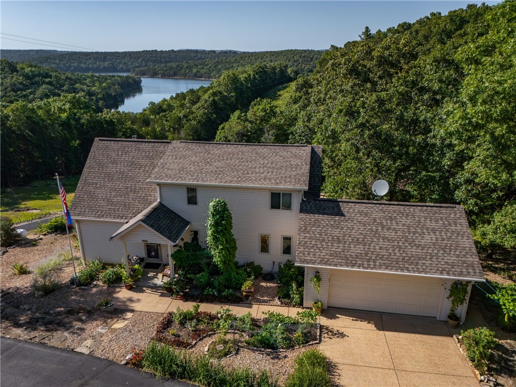 Amazing views of Bull Shoals Lake! This gorgeous home is sitting on 7 acres m/l at the end of the privately owned driveway. Inside you will find amazing views from the main level and the upper level. Primary bedroom is spacious, has a walk-in closet and its own private office/sitting area. This home also features a full basement with its own private kitchen, living space, bedroom and bathroom! If that wasnāt enough to knock your socks off, there is also a detached shop with its own paved driveway leading to it. Plenty of extras with this home, screened porch, central vac system, modern kitchens and bathrooms. Enjoy your own slice of paradise with this one-of-a-kind property. Minutes from White River Access and Bull Shoals Lake Access!