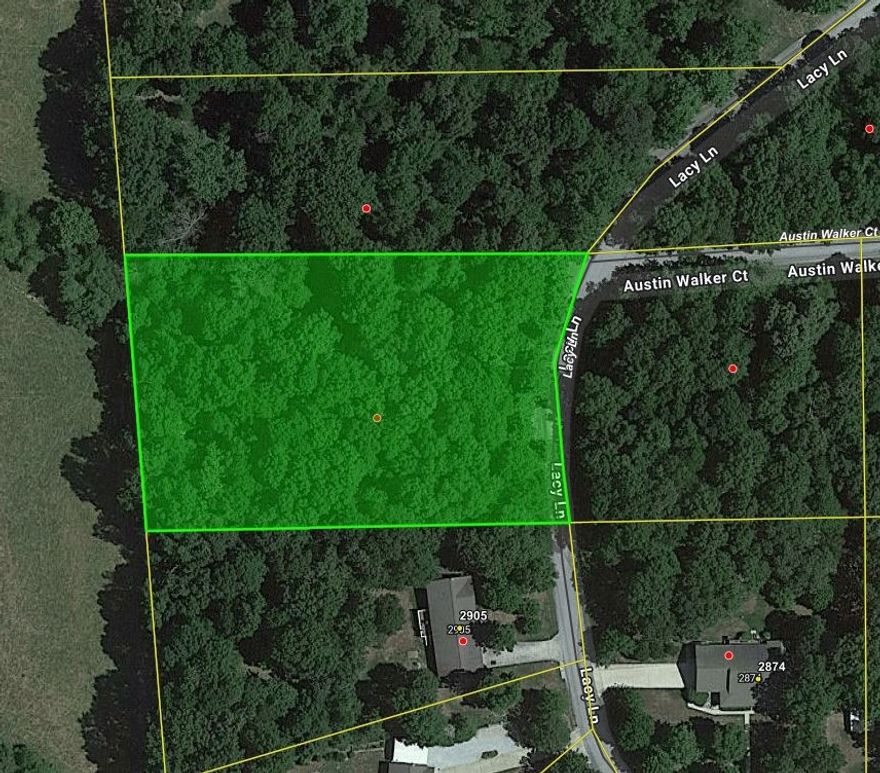 Wooded lot on paved road with water & electric available. Great building site in established neighborhood. No mobile home allowed.