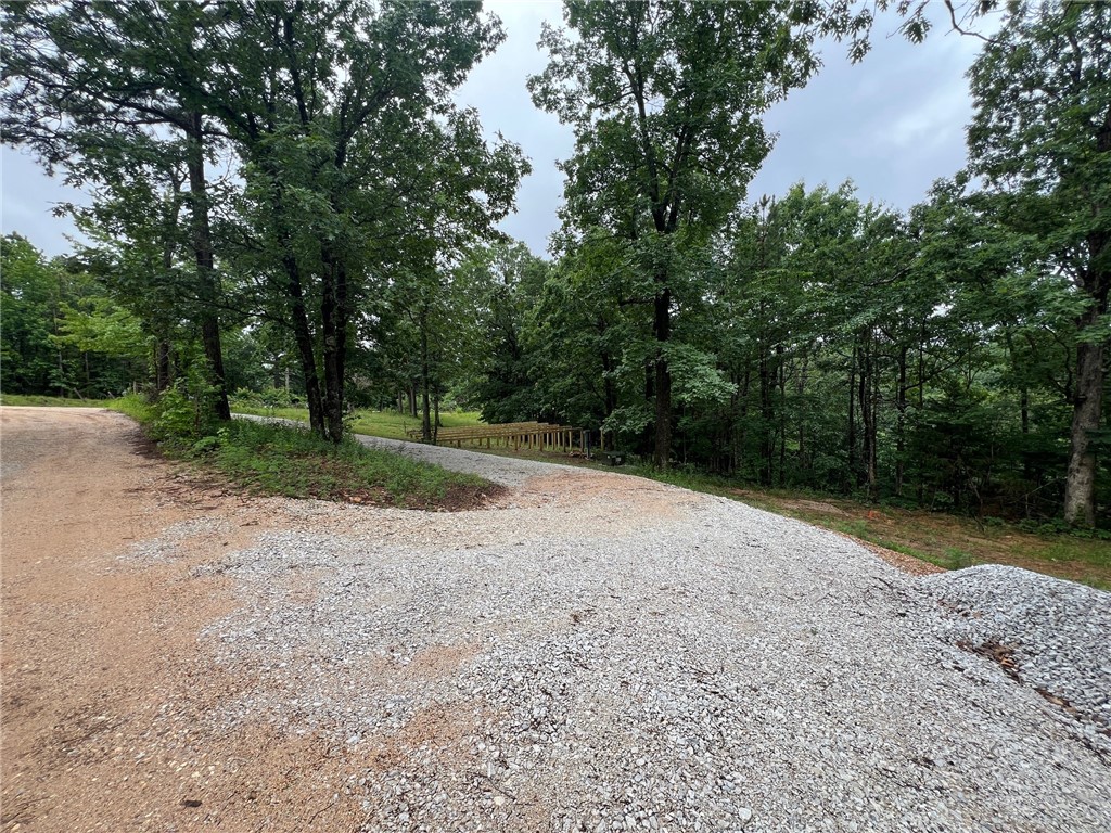 Just under 3 acres in beautiful Jasper AR ready for your dream build. Located with easy access on a corner lot, partially cleared, a cabin has been started and the initial work already done. 25x36 foundation posts in ground with sill plates ready to add framing on. Cabin foundation positioned to take in view off the back and meets a circular gravel driveway to the front. 1000 gallon septic in place, power run, and rural water with meter. Located only 1/4 mile from Scenic Hwy 7, near lots of hiking trails, wildlife viewing, the Arkansas Grand Canyon, and the Buffalo National River.