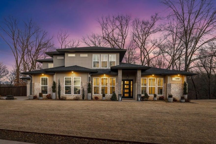 Great layout w/main level bonus, guest ensuite, office & primary suite/3 guest bedrooms on upper level. Spacious 1 AC lot w/private wooded views in backyard. Foyer entry has access to home office on right & half bath plus guest bedroom w/ ensuite on left. Spacious open living area with views into backyard & welcoming flow of space. Dining space w/beautiful lighting. Gourmet kitchen w/ GE Café Prof. Series appliances, Gas Range w/pot-filler, Wine Fridge, Pantry, Double ovens & dishwasher & more! Huge media room w/wet bar and access to the covered deck. Primary suite w/ sitting area, private deck, and bath feat. Soaking tub, walk in shower w/rainfall feature, spacious double vanity and WIC w/access to laundry. Upstairs is access to additional storage & 3 more Bedrooms, 2 sharing J & J bath and 1 with private bath. Home features incl. plantation shutters throughout, auto Blinds in Living and Primary, surround sound, and more. Quick access to 8th St, Downtown & I-49 all in a sought after & well-established community.