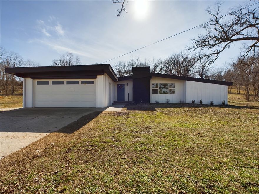 Nestled on 2.6 serene acres, this 1961 mid-century modern home blends timeless design with thoughtful updates. Located 7 minutes from Springdale and Tontitown, an ideal balance of peaceful country living and city convenience.

Step inside to find original beamed ceilings & a spacious, open kitchen perfect for gathering with  friends. The home features three large bedrooms, a huge heated/cooled sunroom, & an oversized bonus office/laundry room, providing plenty of flexible space. Need an extra full bath? The half-bath could easily have a shower added making this home even more functional.

No need to worry about big repairs—new concrete siding, a brand-new roof, fresh interior & exterior paint & a new septic system have all been taken care of. With comparable properties valued at $495K, this home is not only move-in ready but also a fantastic investment.

The park-like setting is perfect for outdoor living. Surrounded by large-acreage properties. Imagine a garden, chickens & wildlife in your own back yard.