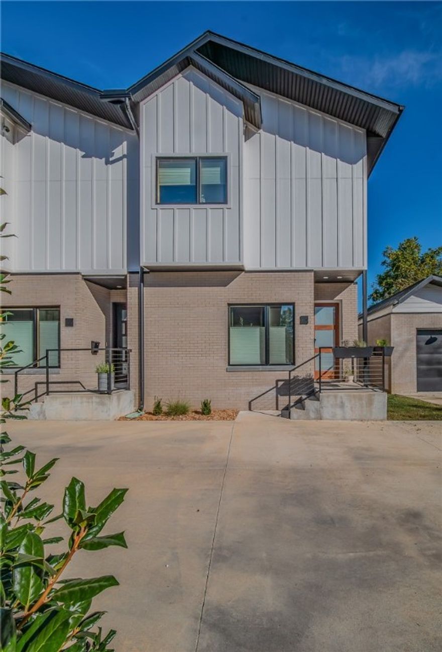 Experience the urban charm of this beautifully maintained 2-bedroom, 2.5-bathroom corner condo within walking distance to downtown Bentonville. Perfect for entertaining, the main floor offers an open concept layout with a spacious living room, half bathroom, and a gourmet eat-in kitchen featuring custom cabinetry, a Kohler farmhouse sink, quartz waterfall countertops, and wine refrigerator. Oversized picture windows fill the space with natural light and showcase beautiful views of the surrounding greenery. Upstairs, the expansive primary bedroom with large walk-in closet is highlighted by a luxurious spa-like bathroom featuring double sinks and an oversized walk-in shower. The secondary bedroom with walk-in closet and custom built-in desk provides an en-suite bathroom with glass, walk-in shower. The neighborhood amenities including a dog park, fire pit with seating, and a pavilion with grill and outdoor kitchen coupled with the proximity to trails and downtown Bentonville, make this stylish condo the perfect home.