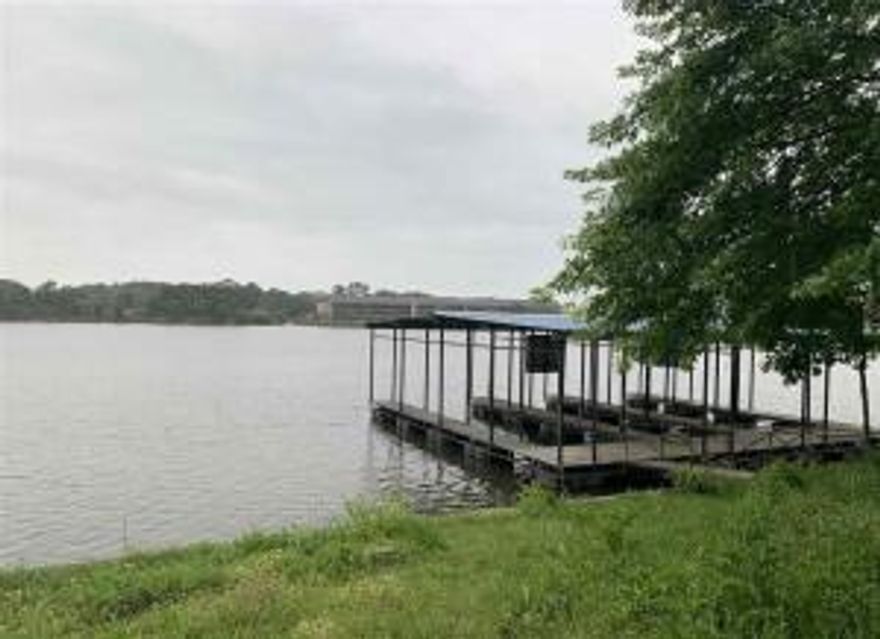 This is a prime piece of development property on Lake Hamilton. Has 176' frontage with boat ramp, swimming dock, and 3 covered boat slips.