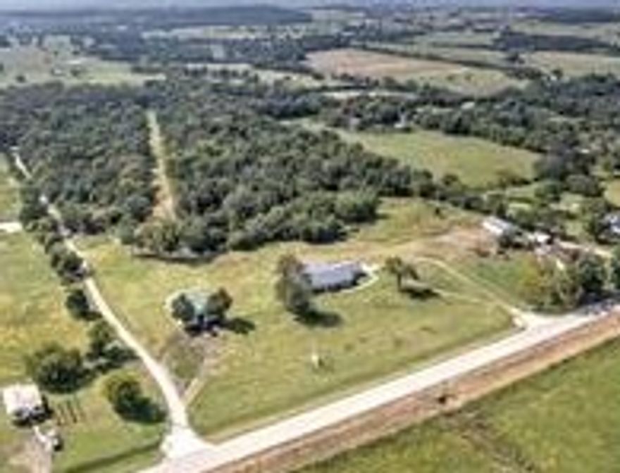 Happy Holidays -Buyers Incentive in amount of $12,000, Bring us a contract in the month of December! The gorgeous updated home includes 3 bedrooms, all of which have private access to 3 restrooms. Large Open kitchen boast bright modern features including granite countertops, vinyl flooring and a hidden pantry space. Matching top of the line appliance will convey. Looking for a man cave or a business opportunity? We have both covered with the 30x40 metal shop building and a second building with 2000 sq ft that was previously the “The Gunman” business, complete with a private pistol range in the rear. Commercial building could easily be converted to a guest home or mother in law unit. Large covered back patio to sip morning coffee or bird watch. Storm shelter is just steps off the back patio. Water softener, whole house generator and 2 fireplaces. 2 shop buildings with electric, Too many features to list all of of them in this beautiful property! 19.68 acres and less than 10 minutes to town Convenience