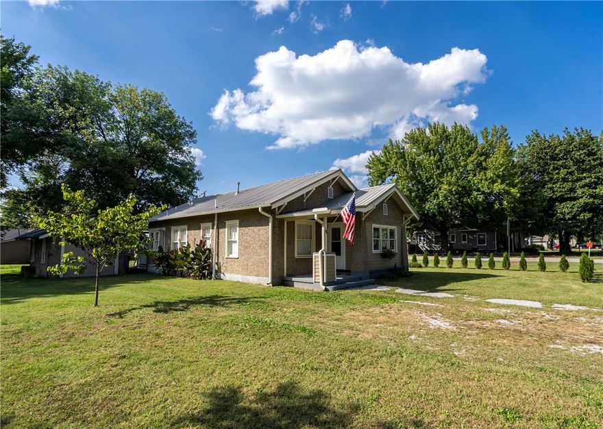 Welcome home to a one of a kind concrete and recycled glass exterior. Close to everything Gentry has to offer.  It has original refinished wood floors, freshly painted walls, new gutters, storm doors and a new partial wood fence for privacy while your setting outside by your firepit enjoying your smores and coffee. It has a nice sunroom for your enjoyment and a storage building for your lawn equipment. Come tour the property before it gone.