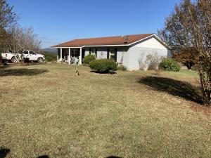 EXCEPTIONAL VIEW! This is a very secluded and private location. Brick home with landscaping and is a nice clean home. The brick was painted a year ago. White eves, trim and shudders. There is a small pond. The property is fenced and has a newer well house. The home has a large open living room,dining room, kitchen floor plan. Master bedroom has a walk-in closet. There is a 8'x12' outbuilding with a lean-to that has 2''x6'' walls.