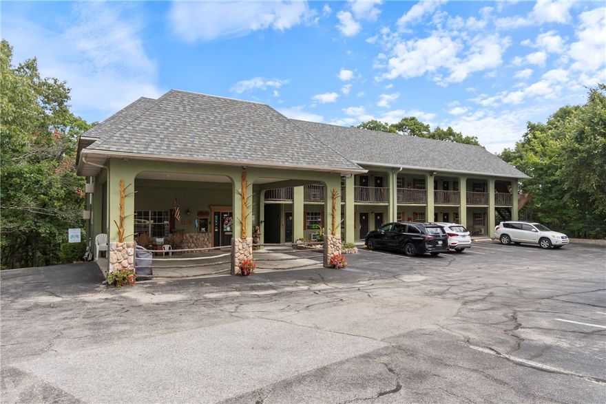 This fully furnished 4-story hotel is situated on +/-1.22 acres of partially wooded land with scenic views and frontage on US Highway 62, just 2 miles from downtown Eureka Springs. The property features 23 guest rooms, including king and two-queen bed layouts, with four rooms boasting private jacuzzi's for an elevated guest experience. Amenities include a pool at the rear of the property, covered bike parking, and convenient access to Public Trolley Stop #51, making it easy for guests to explore the area. The sale also includes a spacious manager’s quarters—a two-story apartment with two bedrooms and two bathrooms—perfect for on-site management. Some recent updates include a full roof replacement in 2024, new carpet installed in all rooms + apartment in 2023, and new RFID locks on all rooms in 2022. This hotel offers an exceptional turnkey opportunity to operate a well-located, fully equipped property in one of Northwest Arkansas’ most popular tourist destinations.