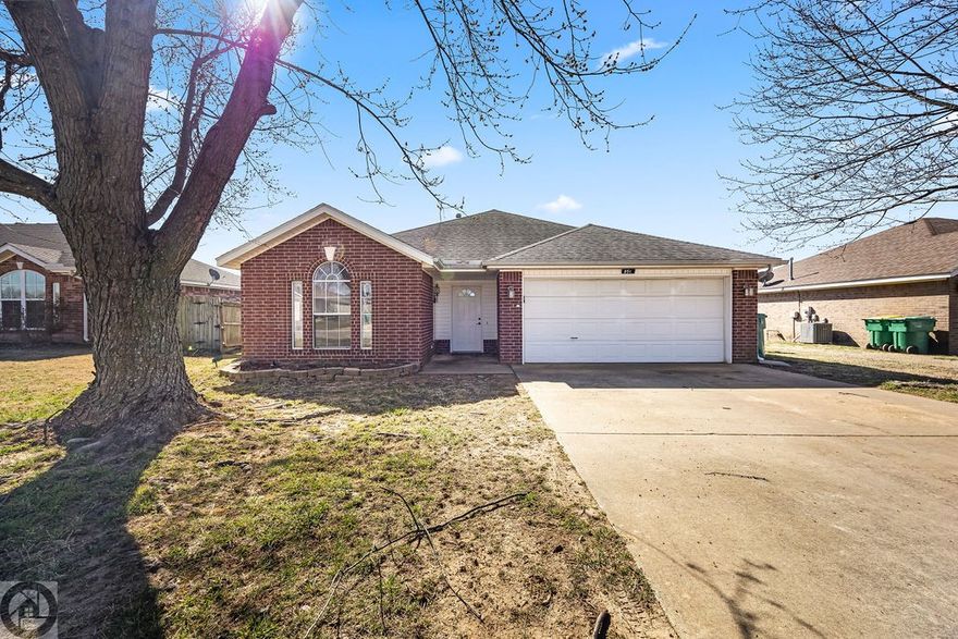Welcome home to this move-in ready, cute all-brick 3-bedroom, 2-bath property with a 2-car garage and a desirable split floor plan offering 1,276 sq ft of comfortable living space. Enjoy tile flooring throughout the kitchen, living room, hallway, and bathrooms, plus wood laminate in all bedrooms—no carpet! The kitchen includes stainless steel appliances, and the primary suite features his & hers walk-in closets and an updated tiled shower in the master bath. Step outside to a privacy-fenced backyard with a storage shed, perfect for extra space and outdoor convenience. Conveniently located in the Bentonville School District, this home is a great option for anyone looking for low-maintenance living in a fantastic area. Call now to schedule a private showing!