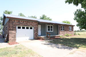 Sitting just outside the city limits, with views of the countryside, and a peaceful spot at the end of the road, you won't find a better place to call home! All rooms feel fresh and ready to move right in! HVAC, metal roof, and windows were replaced in 2011, brand new carpet throughout living and bedrooms, beautifully updated bathrooms, and fresh white paint throughout. You will be entertaining all your friends with the ample outdoor living space you get with 3 enclosed porches! Hot tub (less than 5 years old, 4 seat) will convey with acceptable offer! Make sure you get a chance to see this one before it's too late!