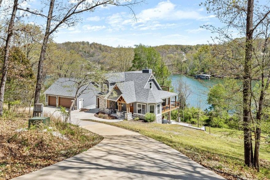 LAKE FRONT HOME WITH PRIVATE 1 STAHL DOCK. Stunning custom home with over 200 ft. of shoreline. Easy walk to the dock from back yard. Located on 2 acres, this home captures lake views from most rooms and from ample outdoor covered and open trek decking. High end finishes throughout including saw-milled hardwood flooring, custom ceiling treatments, granite and marble counter tops, custom tile work, and kitchen island built from antique barnwood. Dual heat range with gas cooktop and electric oven. Wood burning insert and outdoor fireplace. Enjoy the lakeside fire pit and hot tub. 3 car garage with an additional golf cart garage. 4 true bedrooms with an additional room and huge walk out basement/game room with kitchenette.