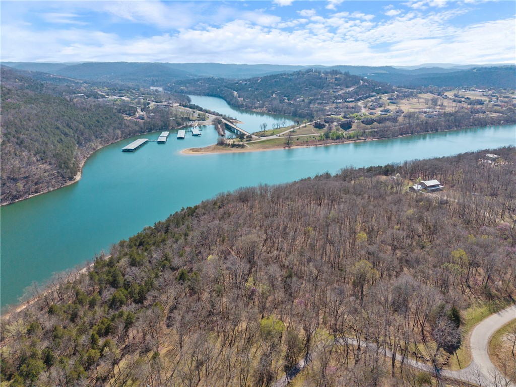 Discover the perfect blend of seclusion and natural beauty with this breathtaking 6.03-acre lakefront property in Oaks Landing, an exclusive subdivision nestled between Table Rock Lake and the Mark Twain National Forest. This pristine lot features two spacious parcels, gently sloping toward the sparkling waters, offering breathtaking views of the lake and the majestic Ozark Mountains with 442 ft of lake front to enjoy. Towering mature hardwoods provide both privacy and a stunning seasonal display of autumn colors and spring blooms. Enjoy easy lake access via the private subdivision-owned swim/fishing dock, or opt for a 28' x 10' boat slip available for purchase at $65,000 via a bill of sale. Whether you're seeking adventure or relaxation, this is your rare opportunity to own a slice of paradiseājust 30 minutes from Eureka Springs and under an hour from Branson or Rogers/Bentonville. Schedule your tour today and start building your dream lakefront retreat!