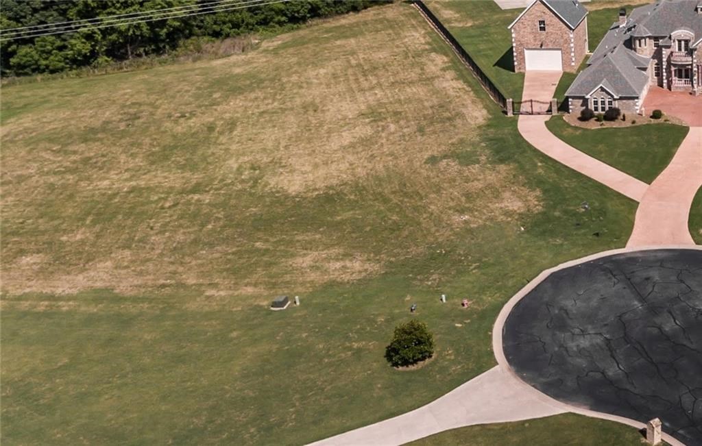 Build your beautiful Custom Dream home on this 2.82 acre property nestled away in a private countryside gated community. Homes ranging form 600 k to over a million.Flat lot located at the end of cul-de-sac. Minimum 3500 sq. ft. home with 1900 on the main level. See attached covenants. Call for more information. Gas & water at street, needs septic. Only 8 minutes to I 49 /or 5 miles I 49 Elm Springs Exit.