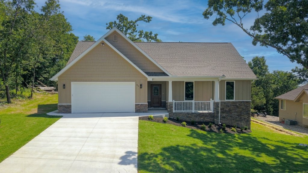 Tucked way on a quiet loop w/ seasonal views of Loch Lomond, this custom-built new construction 3 bed 2 bath split-floor plan home has premium upgrades! Built w/ quality in mind, the interior shines w/ custom solid maple cabinets, quartz countertops, & luxury vinyl plank floors. Kitchen features all SS appliances incl propane range w/ vented hood, custom-tiled backsplash, dimmable LED can & under-cabinet lighting, & pantry w/ outlet for extra appliances. Great room boasts 10’ coffered ceiling, crown molding, & stunning floor-to-ceiling stone fireplace w/ dual blowers. Primary suite offers 10’ step ceiling, curbless oversized walk-in shower, & lg walk-in closet. Enjoy efficiency & convenience w/ 500-gal propane tank, tankless water heater, alarm system prewired for cameras, & transfer switch for whole-house generator w/ dedicated stub on covered patio. 2-car garage is fully insulated & incl sink for easy cleanup. See attached list for all features. Comfort, efficiency, security, & luxury all in a peaceful setting!
